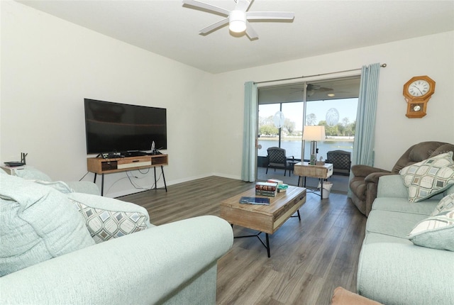 living room with baseboards, wood finished floors, and a ceiling fan