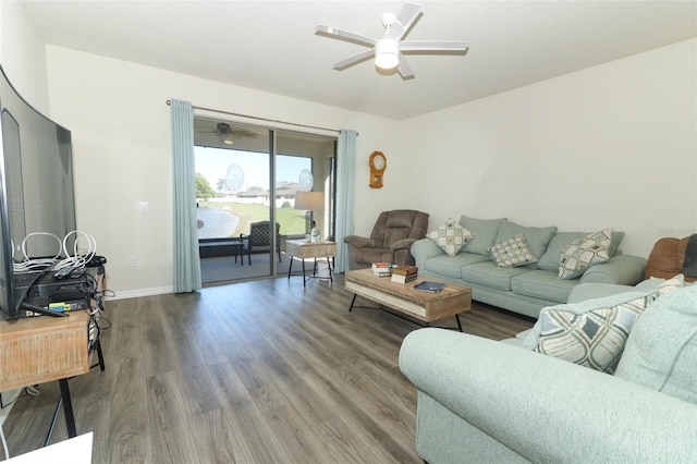 living room with baseboards, ceiling fan, and wood finished floors