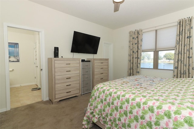 bedroom featuring carpet flooring, baseboards, ensuite bathroom, and ceiling fan