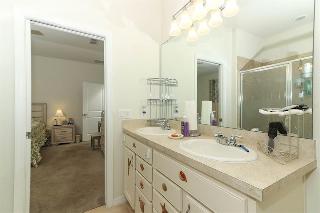 full bath featuring double vanity, visible vents, a stall shower, and a sink