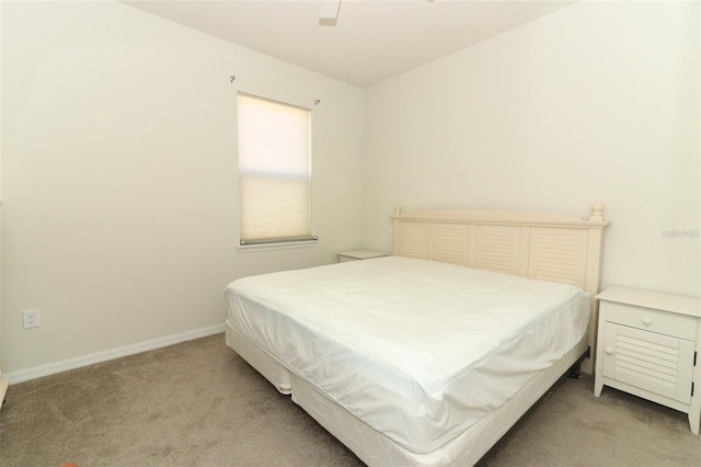 carpeted bedroom with a ceiling fan and baseboards