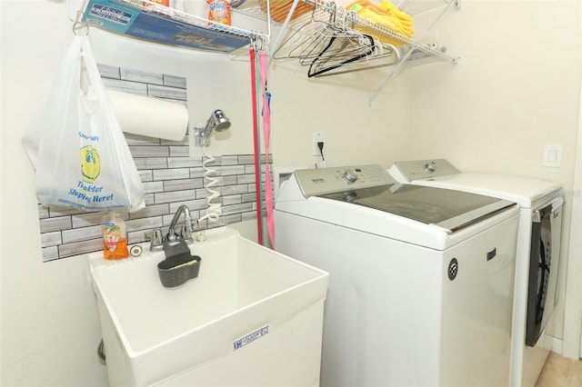 laundry area with washer and dryer, laundry area, and a sink