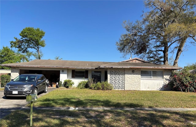 single story home with driveway, a front yard, and a garage