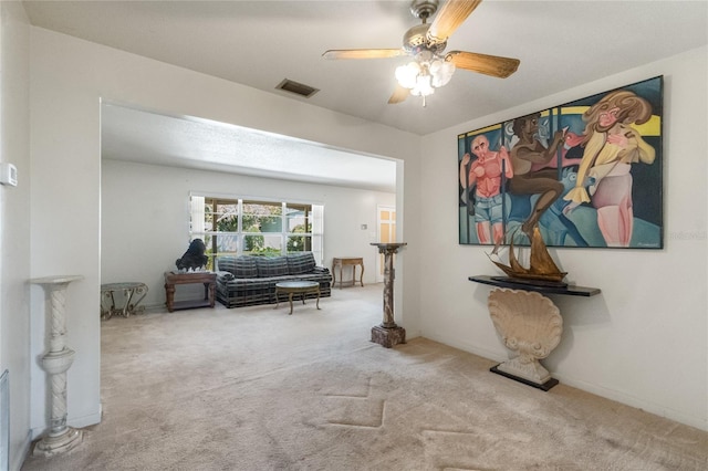 sitting room featuring visible vents, ceiling fan, and carpet flooring