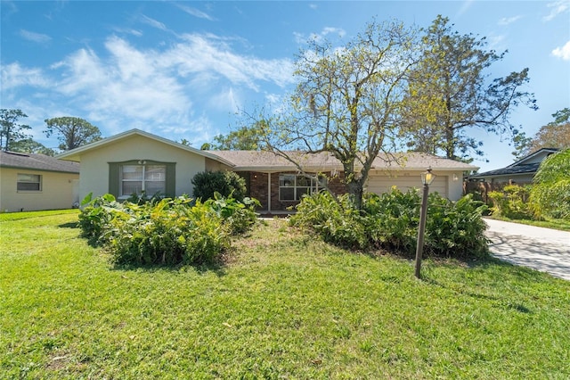 ranch-style house featuring stucco siding, driveway, a front yard, an attached garage, and brick siding