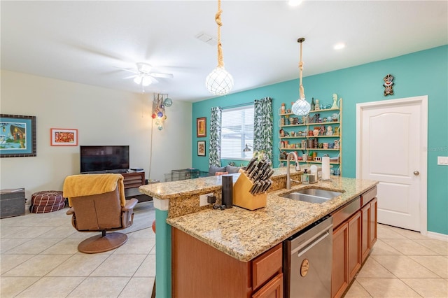 kitchen featuring a sink, stainless steel dishwasher, open floor plan, brown cabinetry, and light tile patterned floors