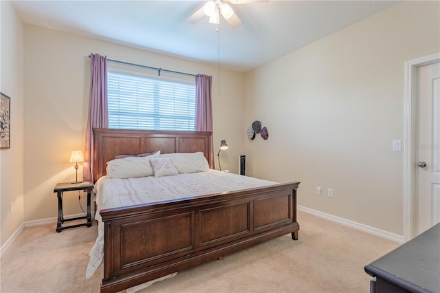 bedroom with baseboards, light carpet, and a ceiling fan