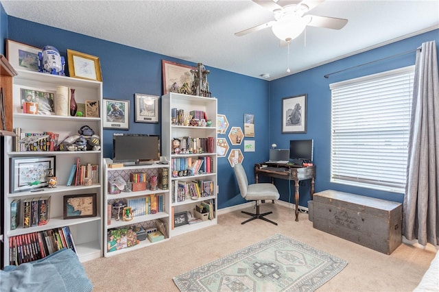 carpeted home office with a textured ceiling, a ceiling fan, and baseboards