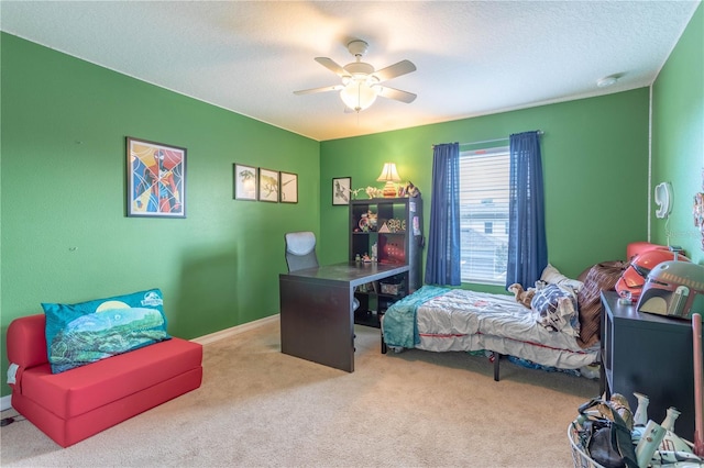 carpeted bedroom featuring baseboards, a textured ceiling, and a ceiling fan