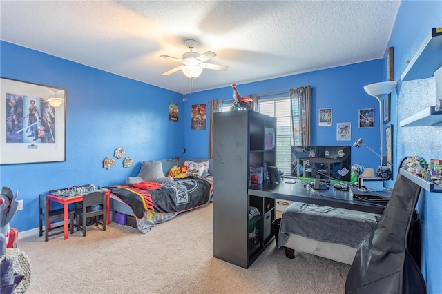 bedroom featuring a ceiling fan, carpet, and a textured ceiling