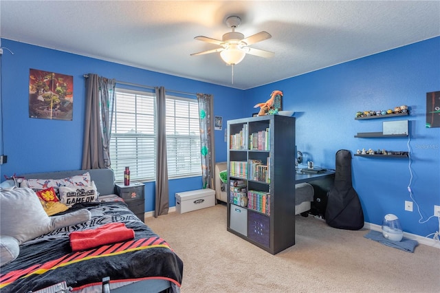 bedroom with carpet flooring, a ceiling fan, baseboards, and a textured ceiling