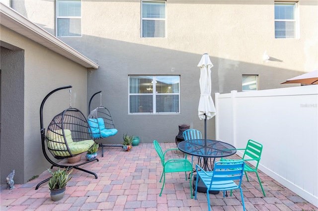 view of patio / terrace with outdoor dining space and fence