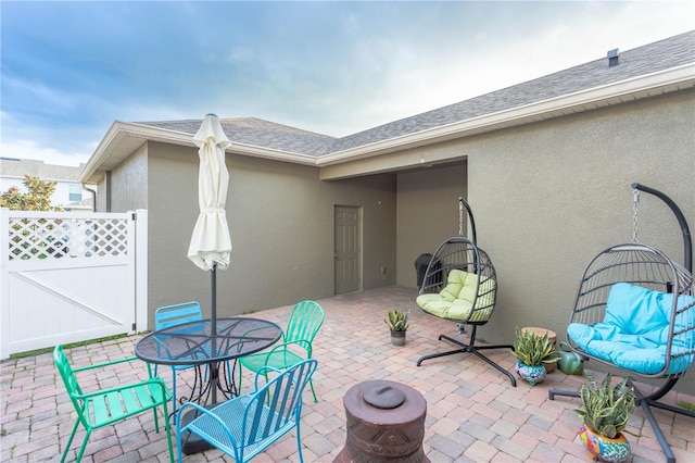 view of patio / terrace featuring a gate, outdoor dining area, and fence