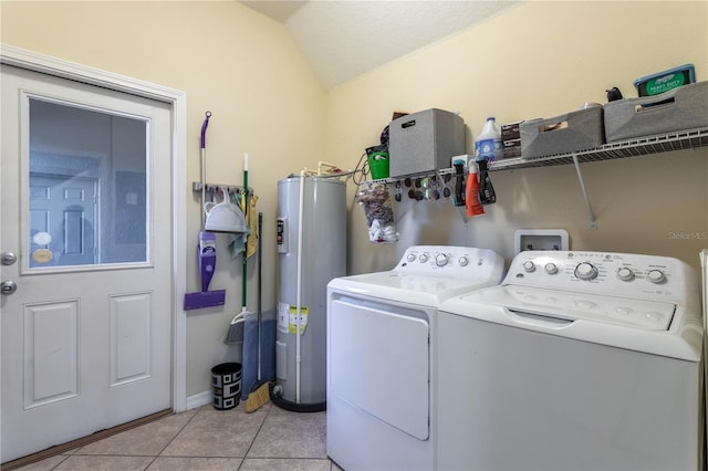 laundry area featuring water heater, laundry area, light tile patterned flooring, and washing machine and clothes dryer