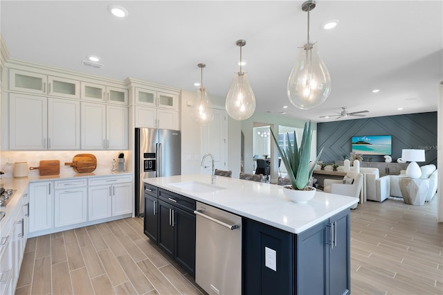 kitchen featuring wood tiled floor, light countertops, recessed lighting, stainless steel appliances, and a sink