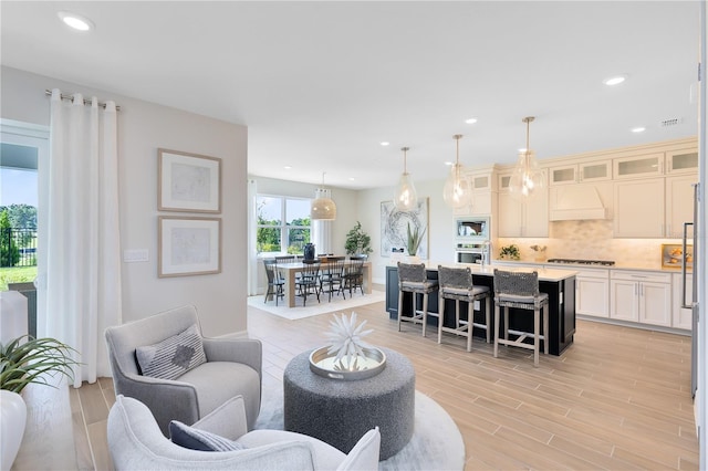 living room with recessed lighting and light wood-style flooring