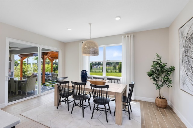 dining space featuring recessed lighting, light wood-type flooring, and baseboards