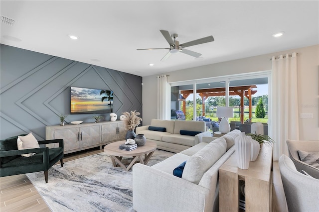 living area featuring light wood finished floors, visible vents, recessed lighting, and a ceiling fan