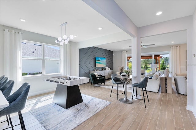 interior space featuring a notable chandelier, recessed lighting, light wood-type flooring, and baseboards