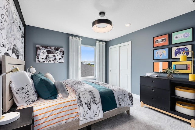 bedroom featuring a closet, baseboards, and carpet floors