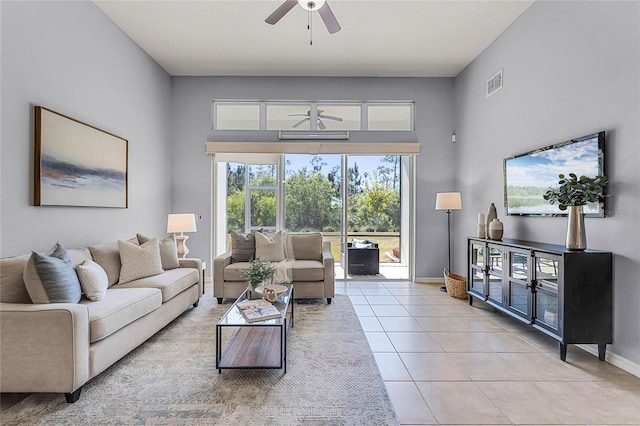 living room with visible vents, baseboards, light tile patterned flooring, and a ceiling fan