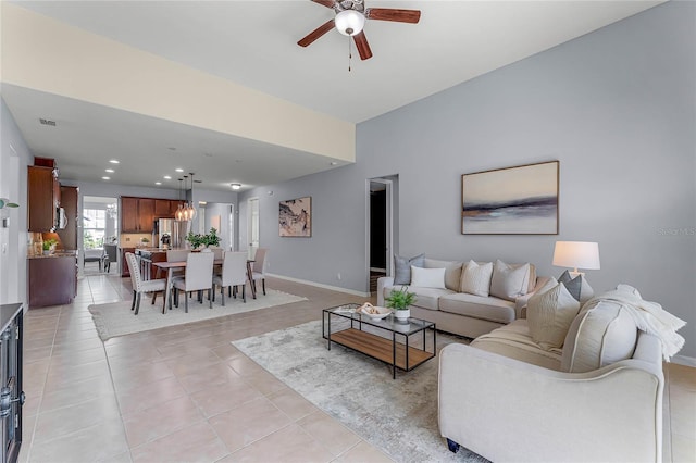 living room featuring recessed lighting, baseboards, light tile patterned flooring, and a ceiling fan