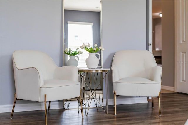 sitting room featuring baseboards and wood finished floors