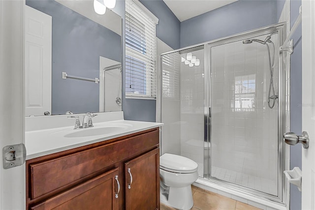 full bathroom featuring tile patterned floors, toilet, a stall shower, and vanity