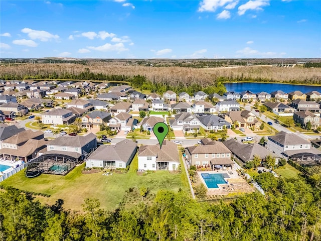 drone / aerial view with a residential view and a water view