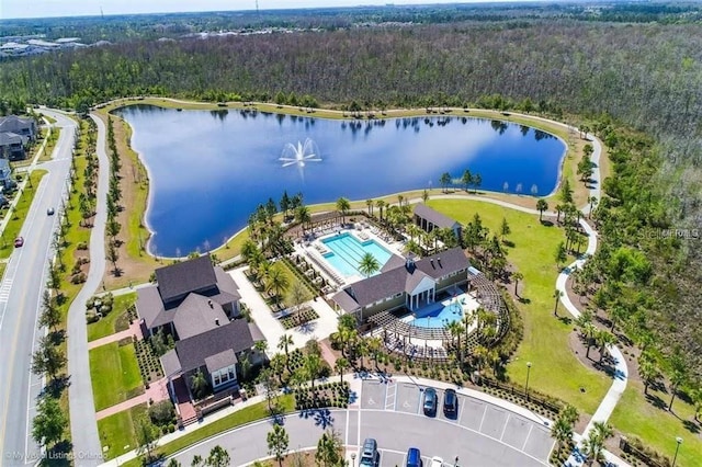 aerial view with a forest view and a water view