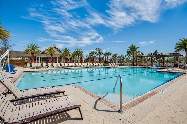 community pool with a patio area and a pergola