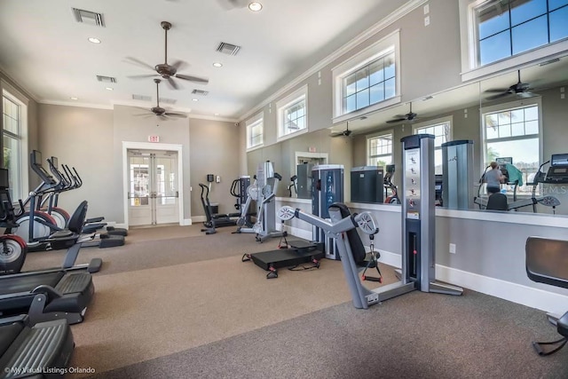 exercise room with visible vents, crown molding, and a ceiling fan