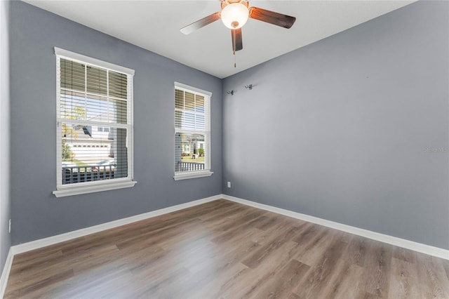 empty room featuring baseboards and wood finished floors