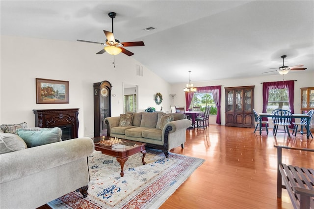 living room with visible vents, light wood-style flooring, and a healthy amount of sunlight