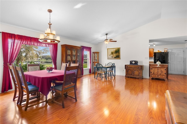 dining area with vaulted ceiling, light wood-type flooring, and ceiling fan