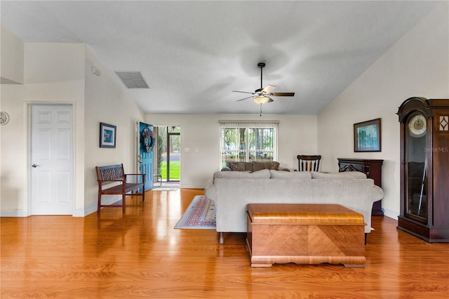 bedroom with visible vents, baseboards, vaulted ceiling, wood finished floors, and a ceiling fan