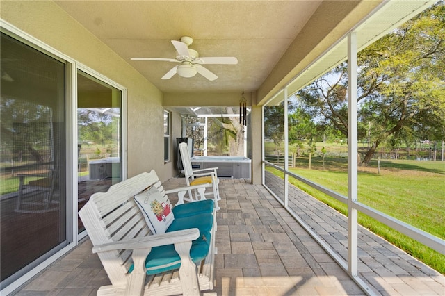 sunroom featuring ceiling fan