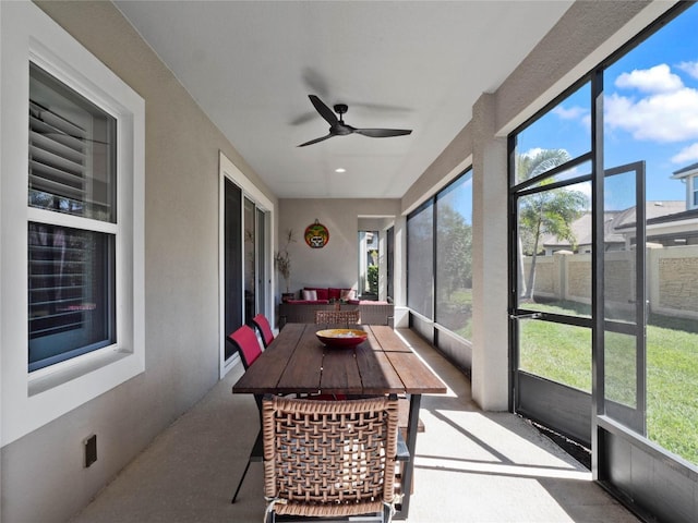 sunroom / solarium with plenty of natural light and ceiling fan