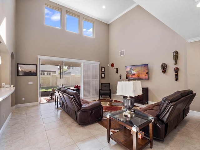 living room featuring arched walkways, visible vents, baseboards, and light tile patterned floors