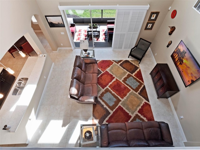 living area with tile patterned floors and baseboards