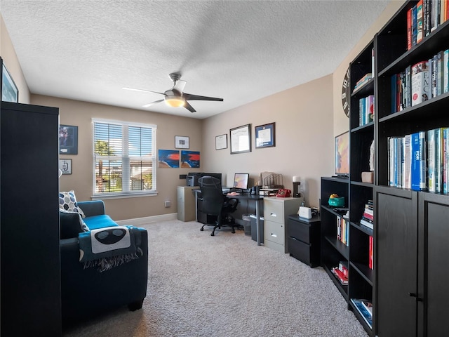 office with baseboards, a textured ceiling, a ceiling fan, and carpet floors