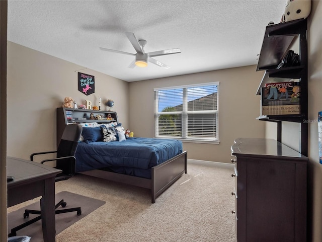 bedroom with carpet flooring, a ceiling fan, baseboards, and a textured ceiling