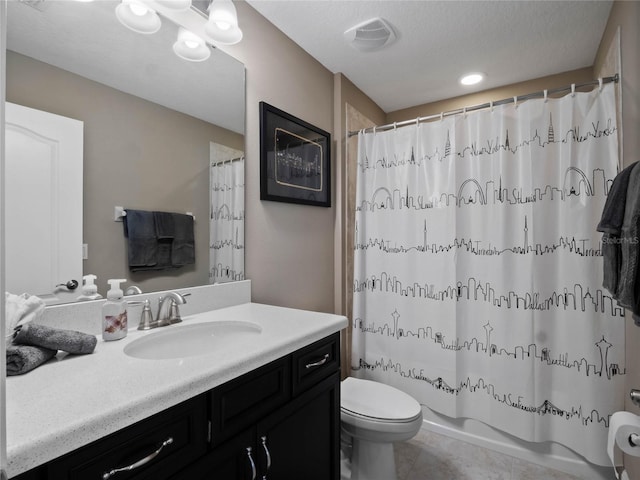 bathroom featuring vanity, visible vents, tile patterned flooring, shower / tub combo, and toilet