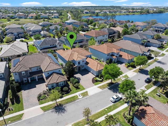 drone / aerial view with a residential view and a water view