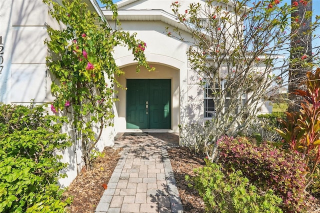 view of exterior entry featuring stucco siding