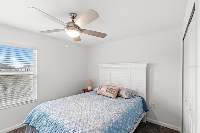 carpeted bedroom with baseboards and ceiling fan