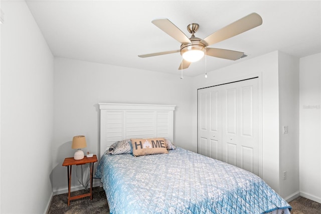 bedroom with baseboards, carpet floors, a closet, and a ceiling fan