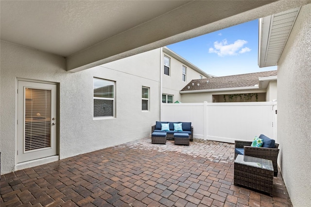 view of patio with an outdoor hangout area and fence