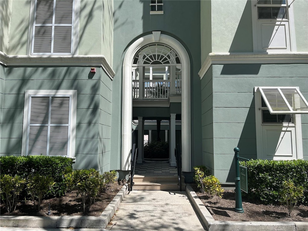 entrance to property featuring stucco siding