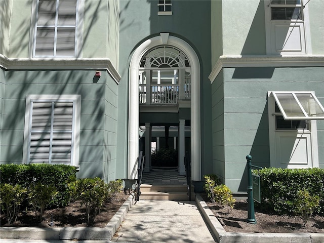 entrance to property featuring stucco siding